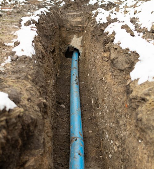 Plumbing pipe laying. Plastic polypropylene pipe. Sanitary, sewer drainage system for a multi-story building. Civil infrastructure pipe, water lines and storm sewers. Selective focus, shallow depth